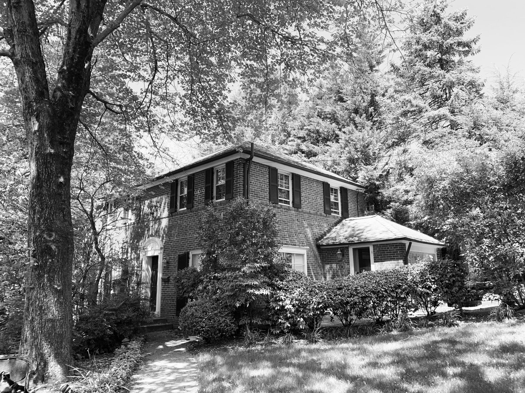 Black and white photo of the original brick house before design began