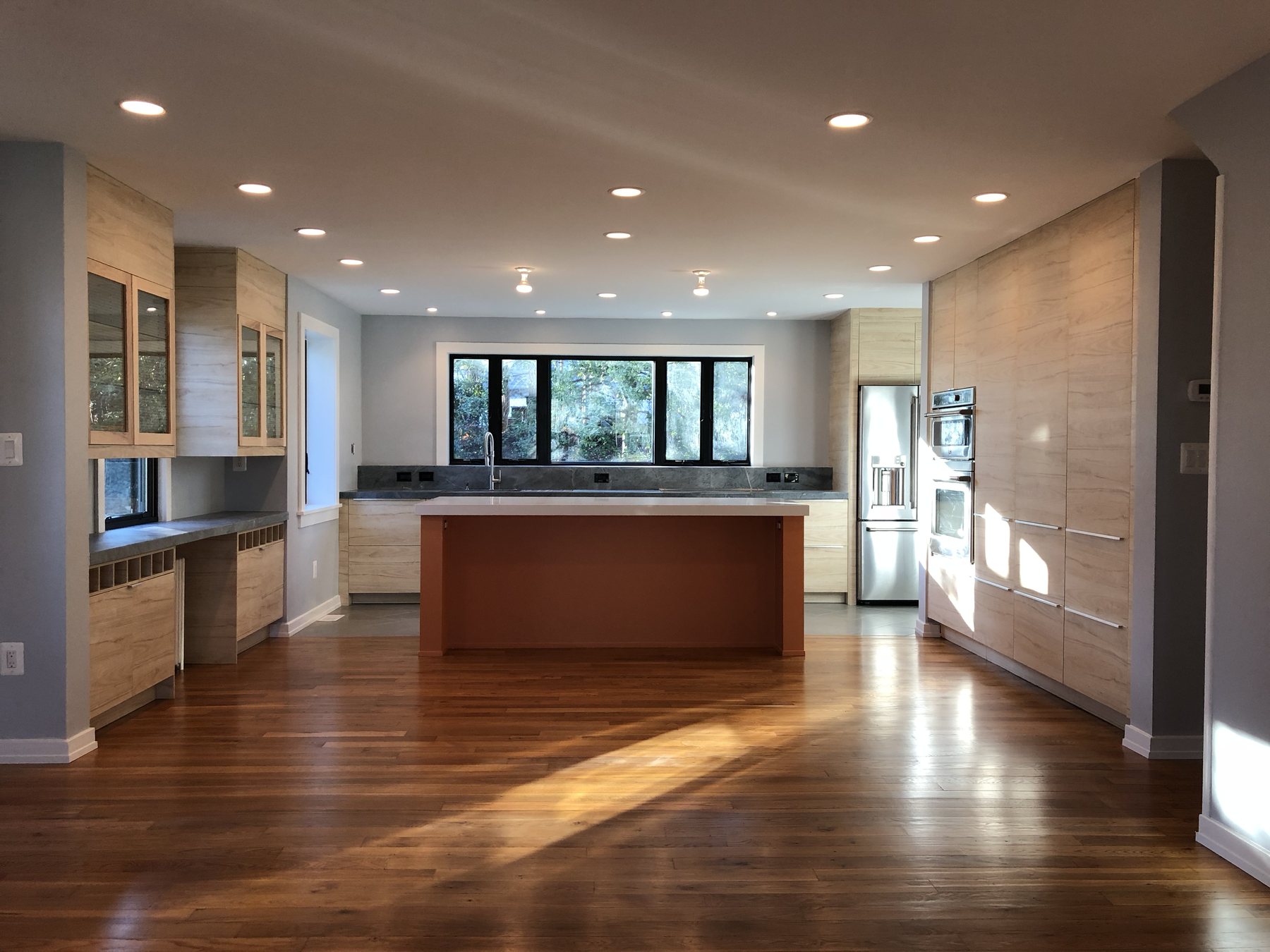 The renovated kitchen at Reason to Stay, one continuous room with an island