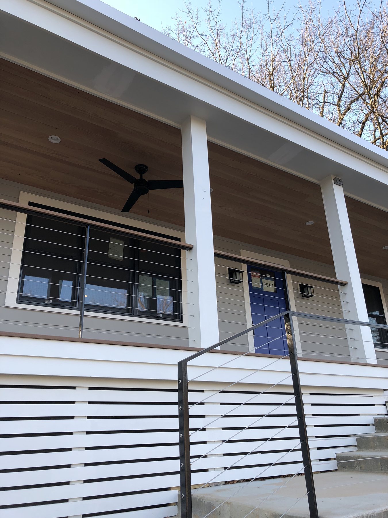 The covered porch, full width, with couches and a hammock