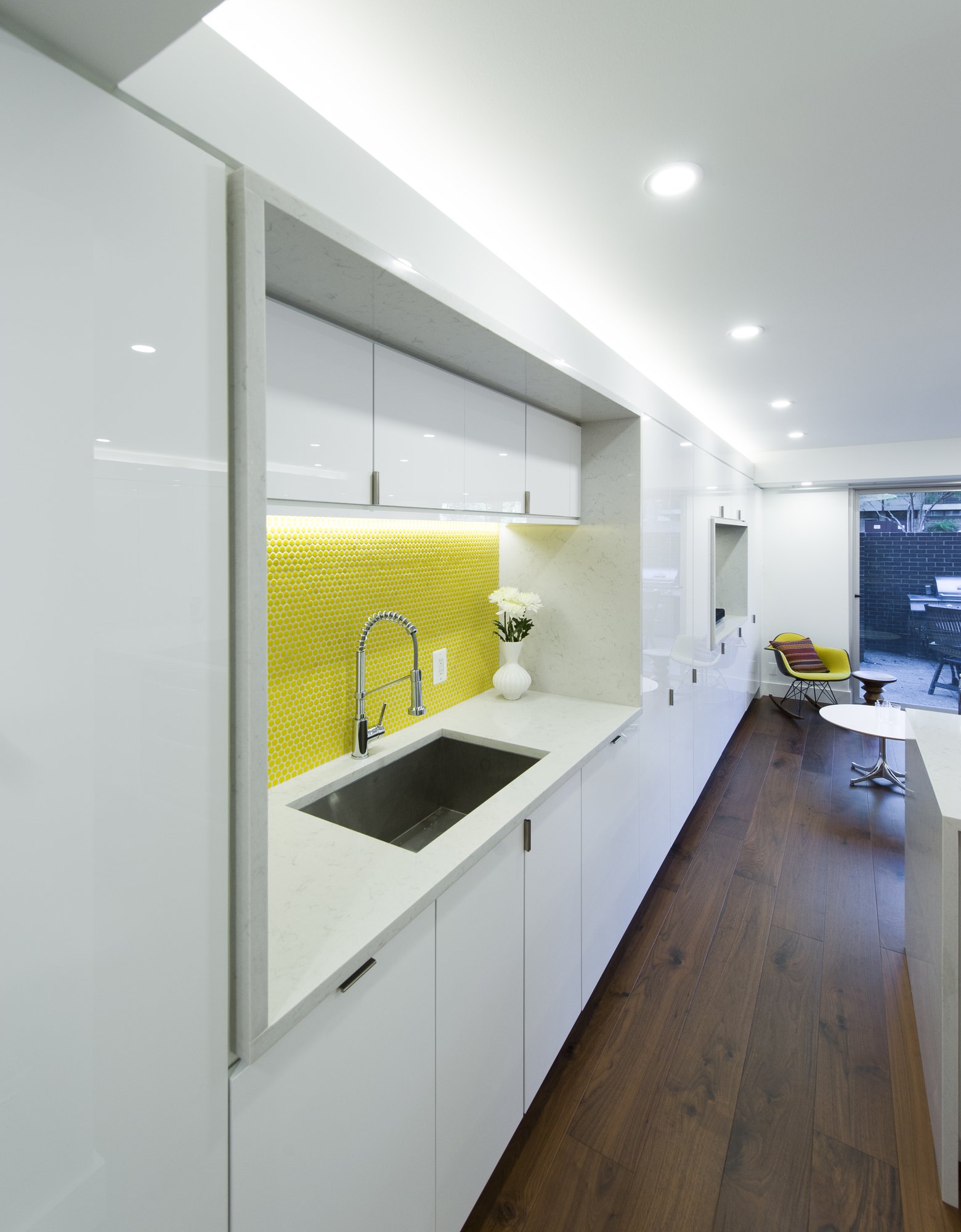 Single transformable room with island, yellow penny-tile niche, and walnut floor, Harbour Square, SW Waterfront, Washington DC